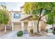 Two-story house with beige exterior, shutters, and landscaping at 7239 Proud Patriot St, Las Vegas, NV 89148