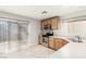 Kitchen with light wood cabinets, tile floor and stainless steel appliances at 7239 Proud Patriot St, Las Vegas, NV 89148