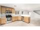 Bright kitchen with stainless steel appliances and light wood cabinets at 7239 Proud Patriot St, Las Vegas, NV 89148