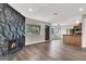 Bright living room with stone fireplace and wood-look floors at 733 Rock Springs Dr # 201, Las Vegas, NV 89128