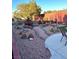 Backyard landscaping featuring a fire pit, cacti, and a stone patio at 7415 Constantinople Ave, Las Vegas, NV 89129