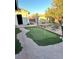 The lush backyard offers a paved stone walkway and putting green at 7415 Constantinople Ave, Las Vegas, NV 89129