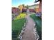 The backyard oasis features a serene walking path and lush artificial turf at 7415 Constantinople Ave, Las Vegas, NV 89129