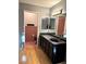 Bathroom with dark wood vanity, granite countertop, and pink tile shower at 7415 Constantinople Ave, Las Vegas, NV 89129