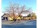 The exterior features mature trees, xeriscaping and a large gravel area at 7415 Constantinople Ave, Las Vegas, NV 89129