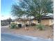 Inviting single-story home featuring desert landscaping and mature tree in front yard at 7415 Constantinople Ave, Las Vegas, NV 89129