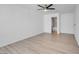 Bright bedroom with wood-look floors, ceiling fan, and en-suite bathroom at 7933 Delbonita Ave, Las Vegas, NV 89147