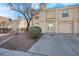 Two-story stucco home with attached garage and landscaped front yard at 7933 Delbonita Ave, Las Vegas, NV 89147