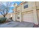 Two-story stucco home with attached garage and driveway at 7933 Delbonita Ave, Las Vegas, NV 89147