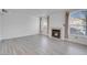 Living room with fireplace, light grey flooring, and large windows at 7933 Delbonita Ave, Las Vegas, NV 89147