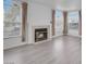 Living room with fireplace, light grey flooring, and large windows at 7933 Delbonita Ave, Las Vegas, NV 89147