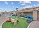 Large backyard with patio, play area, and artificial turf at 8044 Edward Baher Ave, Las Vegas, NV 89149