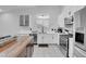 Modern kitchen with white shaker cabinets, stainless steel appliances and a butcher block island at 8044 Edward Baher Ave, Las Vegas, NV 89149