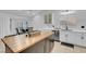 Modern kitchen with white shaker cabinets, a butcher block island, and stainless steel appliances at 8044 Edward Baher Ave, Las Vegas, NV 89149