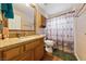 Bathroom with granite countertop, shower, and patterned curtain at 8212 Bolingbrook Ave, Las Vegas, NV 89149