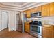 Stainless steel appliances and wood cabinets in kitchen at 8212 Bolingbrook Ave, Las Vegas, NV 89149