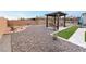 Landscaped backyard with pergola, seating area, and gravel at 8750 Lutts St, Las Vegas, NV 89131