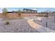 Landscaped backyard with gravel, pathways, and raised garden beds at 8750 Lutts St, Las Vegas, NV 89131