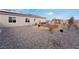 Landscaped backyard with gravel, raised garden beds, and solar panels at 8750 Lutts St, Las Vegas, NV 89131