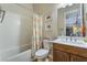 Bathroom with tub, shower, and wood cabinets at 8750 Lutts St, Las Vegas, NV 89131