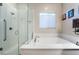 Bathroom with soaking tub, walk-in shower, and modern fixtures at 8750 Lutts St, Las Vegas, NV 89131