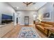 Bedroom with leather sofa, wood floors, and large windows at 8750 Lutts St, Las Vegas, NV 89131