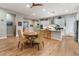 Open dining area with wood table and chairs, hardwood floors, and kitchen views at 8750 Lutts St, Las Vegas, NV 89131