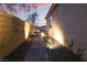 Landscaped side yard with pathway and lighting at 8750 Lutts St, Las Vegas, NV 89131