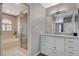 Elegant bathroom with a soaking tub, shower, and white cabinets at 9330 Golden Timber Ln, Las Vegas, NV 89117