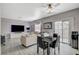 Dining area with glass table and four chairs, adjacent to living room at 9330 Golden Timber Ln, Las Vegas, NV 89117