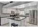 Modern kitchen featuring white cabinets, granite countertops, and stainless steel appliances at 9330 Golden Timber Ln, Las Vegas, NV 89117