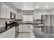 Modern kitchen with white cabinets, granite countertops, and stainless steel appliances at 9330 Golden Timber Ln, Las Vegas, NV 89117