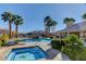 Community pool and spa with lounge chairs and surrounding landscaping at 9330 Golden Timber Ln, Las Vegas, NV 89117