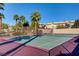 Community tennis court with surrounding palm trees and residential buildings at 9330 Golden Timber Ln, Las Vegas, NV 89117