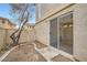 Small backyard with gravel landscaping and sliding glass door access at 947 Cantabria Heights Ave, Las Vegas, NV 89183