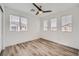 Well-lit bedroom with hardwood floors and multiple windows at 947 Cantabria Heights Ave, Las Vegas, NV 89183