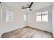 Bright bedroom with ceiling fan, wood-look floors, and window blinds at 947 Cantabria Heights Ave, Las Vegas, NV 89183