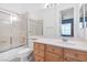 Bathroom featuring a shower-tub combo with sliding glass doors and a wood-look vanity with a white countertop at 99 Teton Pines Dr, Henderson, NV 89074