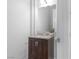 Cozy bathroom featuring a single sink vanity with a dark wood cabinet, granite countertop, and silver hardware at 99 Teton Pines Dr, Henderson, NV 89074