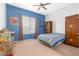 Bedroom with a large window, carpet, and a blue accent wall, and wood furniture at 99 Teton Pines Dr, Henderson, NV 89074