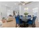 Bright dining room featuring blue chairs, tile flooring, and decorative lighting at 99 Teton Pines Dr, Henderson, NV 89074