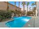 Inviting backyard pool and spa area surrounded by mature palms and lush greenery at 99 Teton Pines Dr, Henderson, NV 89074