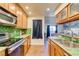 Kitchen features wood cabinets, green tile backsplash, and modern appliances at , Las Vegas, NV 89147