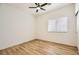 This is a bedroom with a ceiling fan, a window with blinds, and wood-look flooring at 10282 Country Flats Ln, Las Vegas, NV 89135