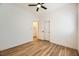 Bedroom features wood-look floors, a ceiling fan, closets and access to hallway and storage at 10282 Country Flats Ln, Las Vegas, NV 89135