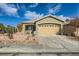 Front view of a single-story house with a two-car garage at 10282 Country Flats Ln, Las Vegas, NV 89135