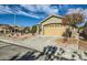 House exterior featuring a two-car garage and desert landscaping at 10282 Country Flats Ln, Las Vegas, NV 89135