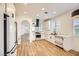 Open-concept kitchen features white cabinetry, stainless steel appliances, and wood-style flooring at 10282 Country Flats Ln, Las Vegas, NV 89135