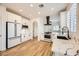 Modern kitchen with white cabinets, marble counters and black sink at 10282 Country Flats Ln, Las Vegas, NV 89135