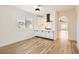 Modern kitchen with white cabinets, marble countertops and island at 10282 Country Flats Ln, Las Vegas, NV 89135